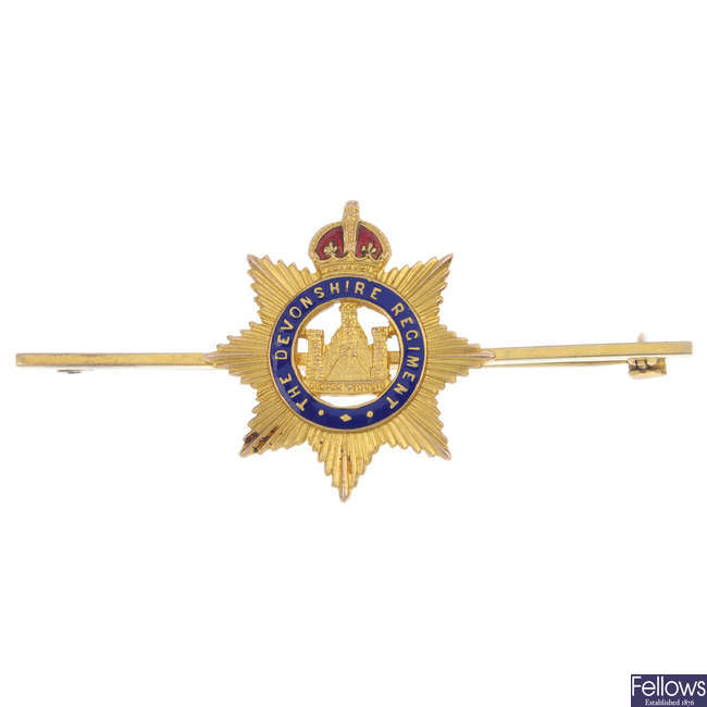 A mid 20th century 9ct gold Devonshire Regiment enamel brooch.
