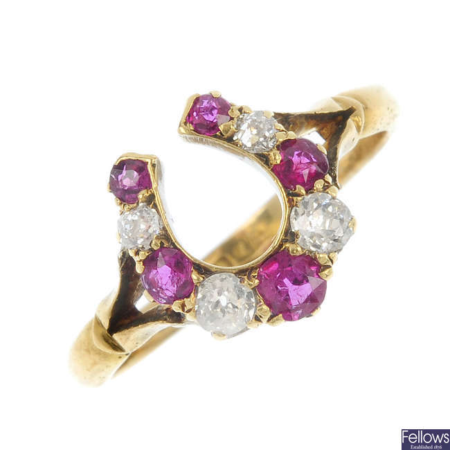 An early 20th century 18ct gold ruby and diamond horseshoe ring.