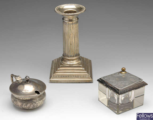 A silver candlestick, mustard &  inkwell.