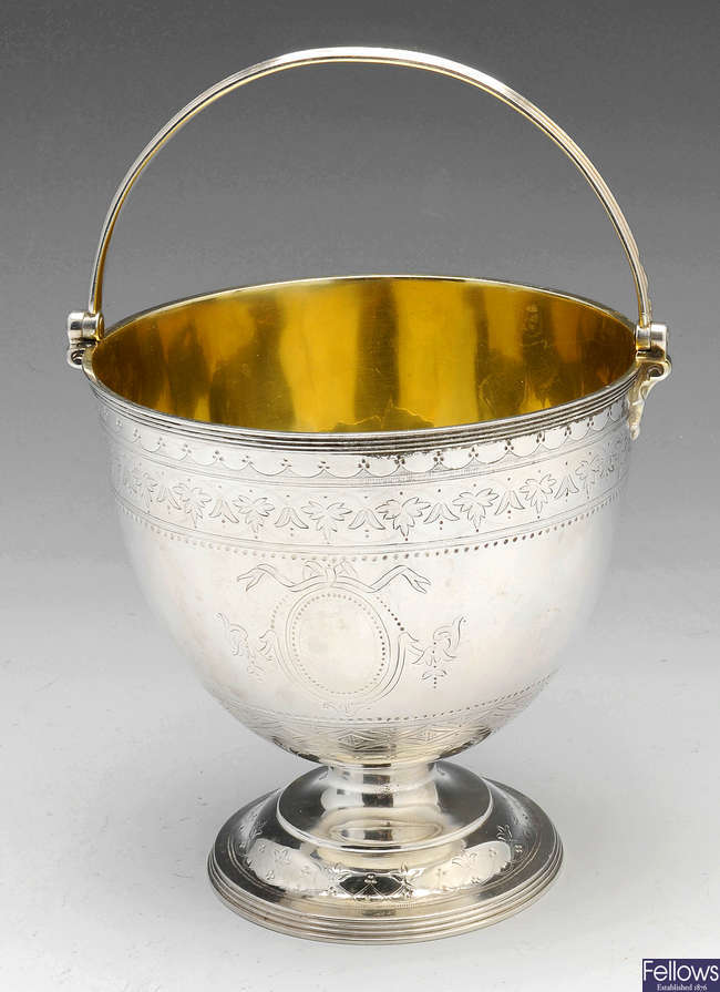 A Victorian silver sugar bowl with swing handle.