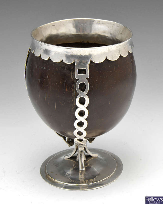A white metal mounted coconut cup, unmarked.
