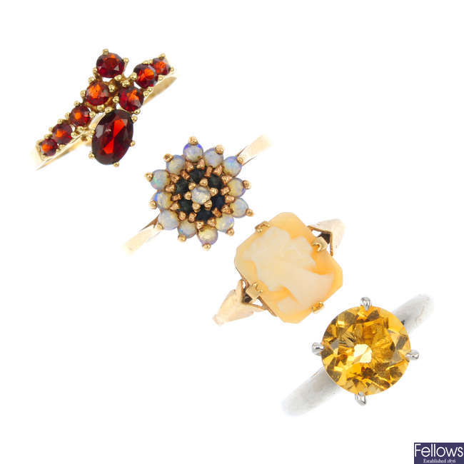 A selection of four gem-set rings.
