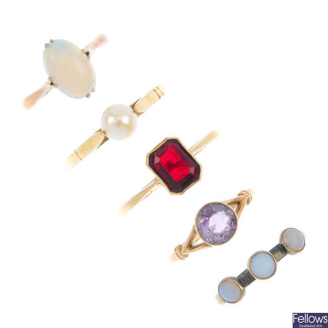 A selection of five gem-set rings.