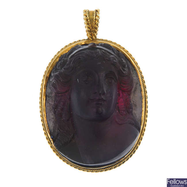 A late 19th century gold amethyst cameo pendant.
