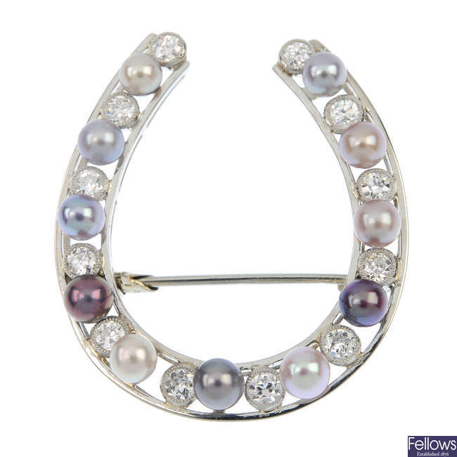A diamond and cultured pearl horseshoe brooch.