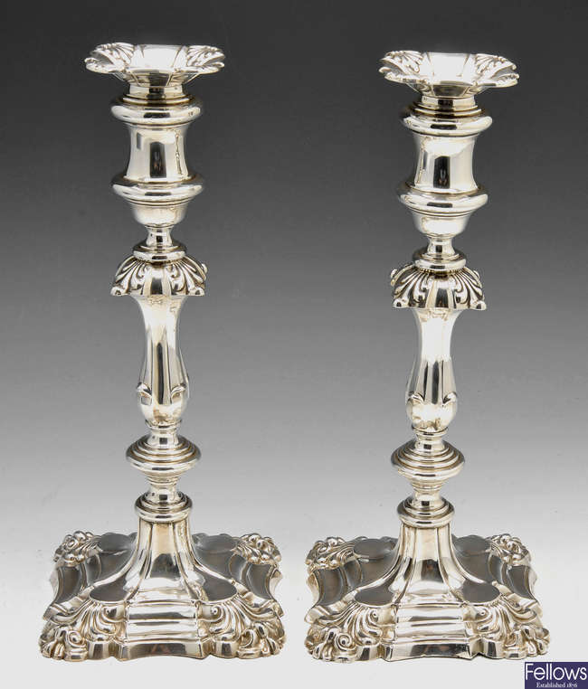 A pair of Edwardian silver mounted candlesticks.