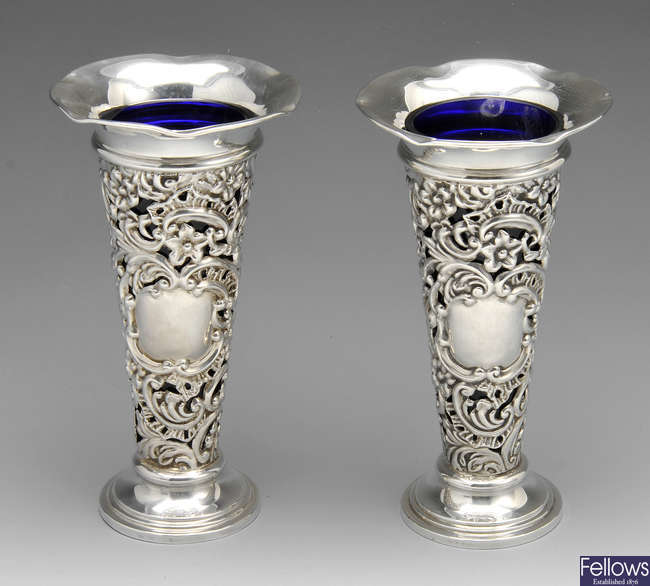 A pair of late Victorian silver mounted vases.