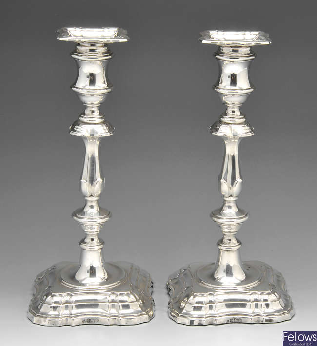 A pair of Edwardian silver candlesticks.