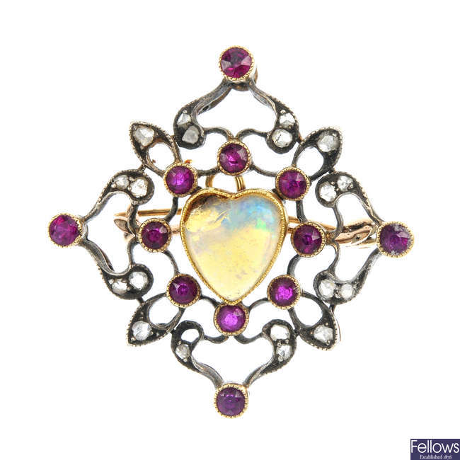 An early 20th century silver and gold opal, ruby and diamond brooch.