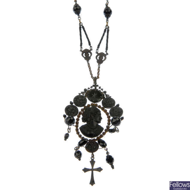 A late 19th century Czechoslovakian steel and glass pendant and a niello belt.