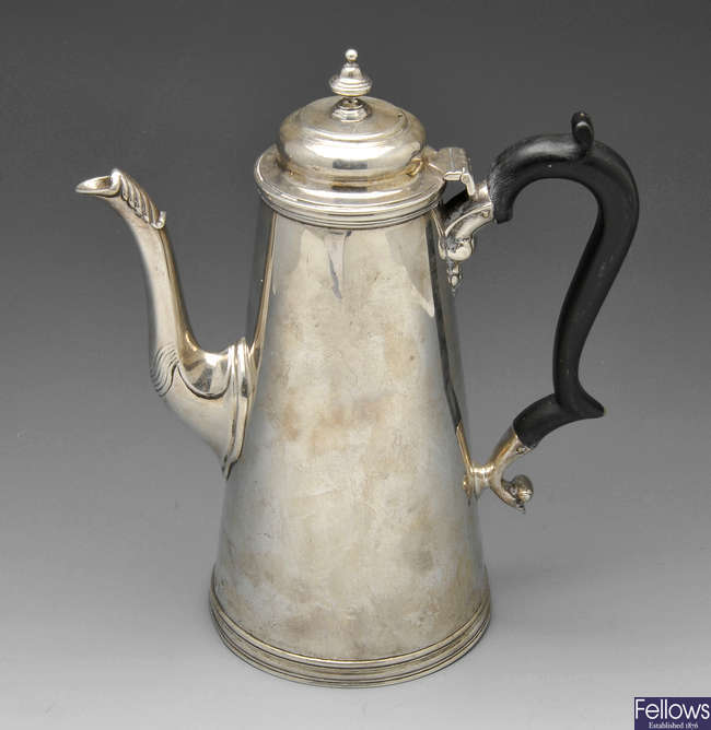 A late Victorian silver coffee pot with engraved armorial.