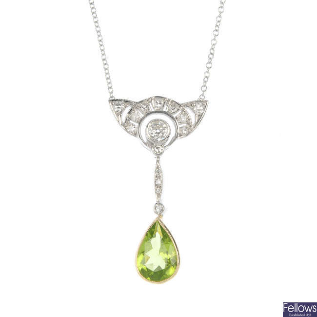 A peridot and diamond pendant.