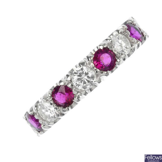 An 18ct gold ruby and diamond half-circle eternity ring.