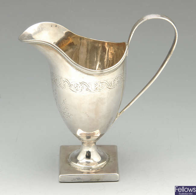 A George III silver helmet cream jug.
