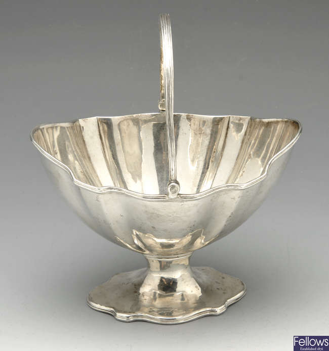 A George III silver swing-handled sugar basket.