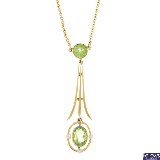 An early 20th century gold peridot and seed pearl pendant.