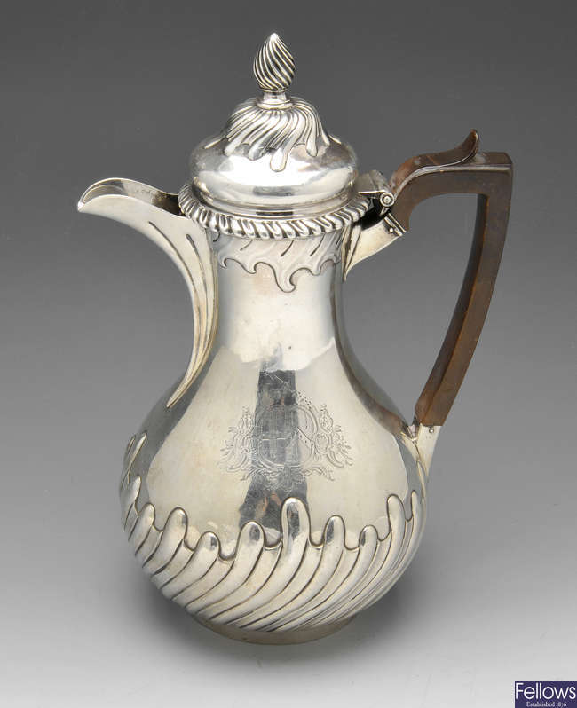 A George II silver hot water pot.