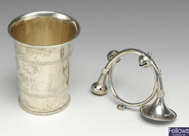An Edwardian silver rattle & an early 20th century beaker.