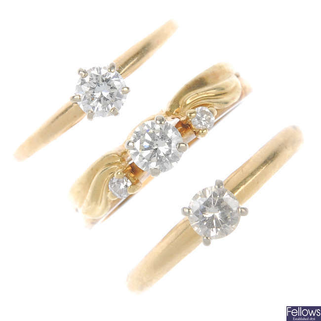 A selection of three diamond single-stone rings.