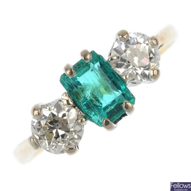 An early 20th century 18ct gold emerald and diamond three-stone ring.
