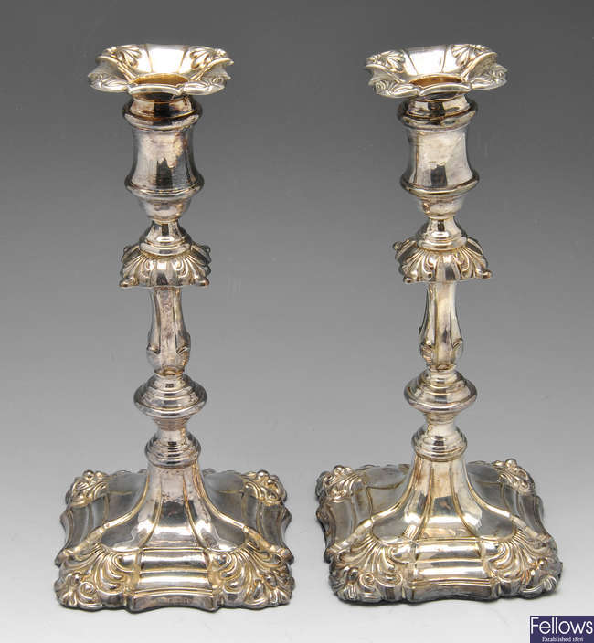 An Edwardian pair of silver mounted candlesticks.