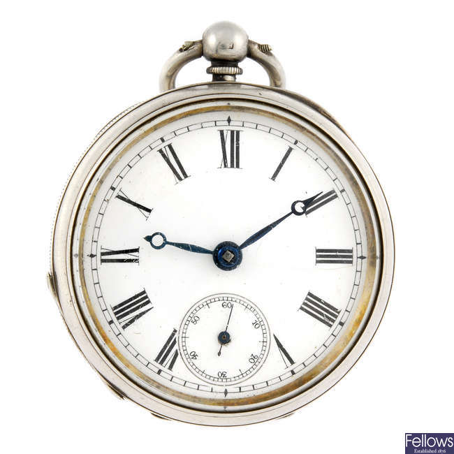 An open face pocket watch with a white metal pocket watch.