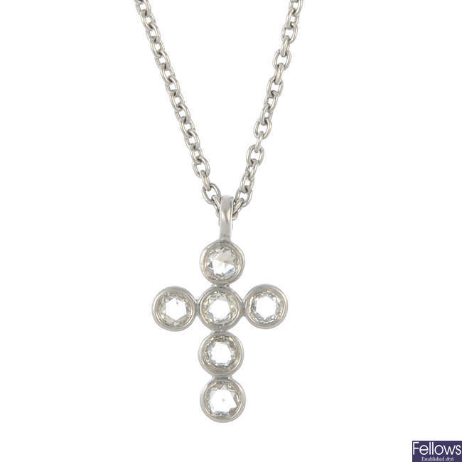 A diamond cross pendant and chain.