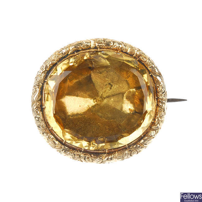 A late 19th century gold citrine brooch and a late 19th century gold monocle.
