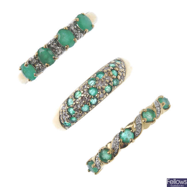 A selection of three diamond and emerald half-circle eternity rings.