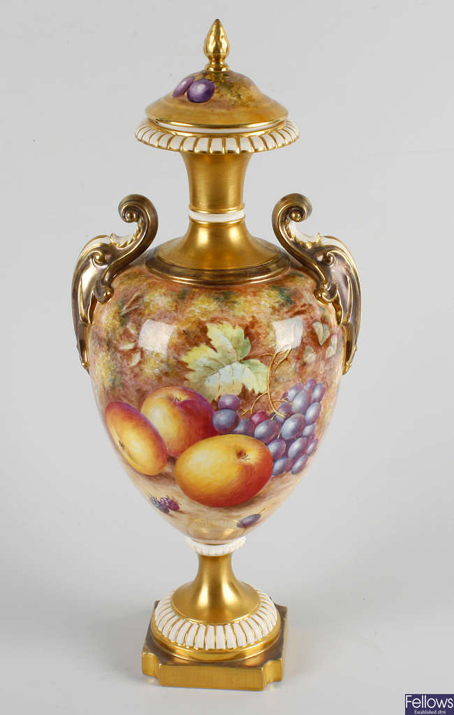 A Royal Worcester bone china twin handled pedestal vase and cover