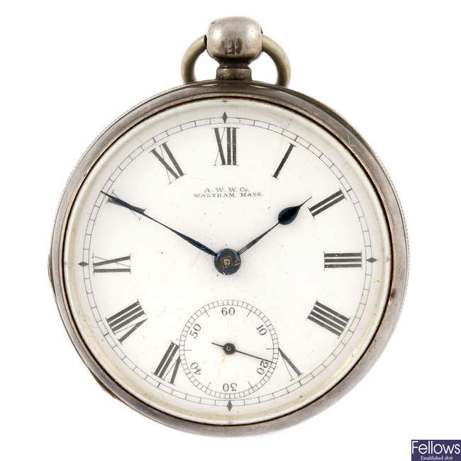 An open face pocket watch by Waltham with a silver trench watch.
