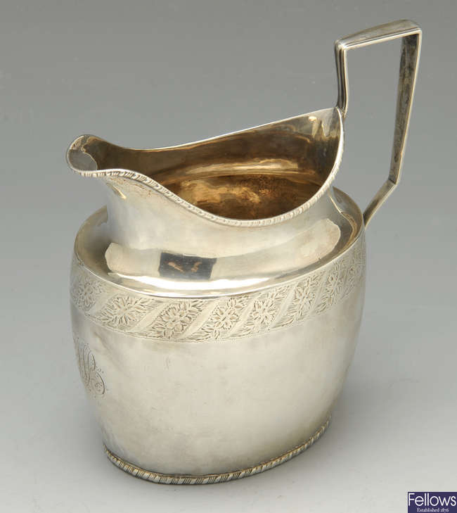 A George III silver cream jug & Edwardian example.