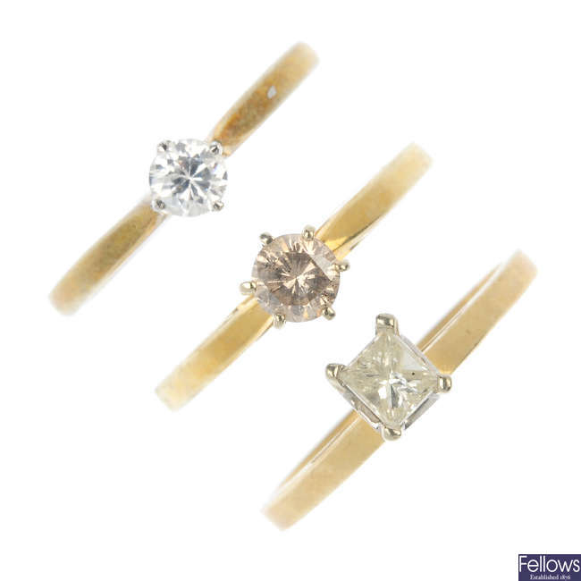 A selection of six diamond and gem-set single-stone rings.