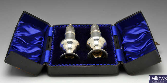 A cased pair of Edwardian silver casters.