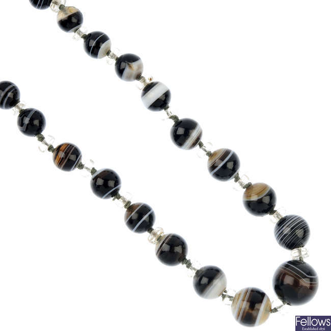 An early 20th century banded agate and glass bead single-strand necklace.