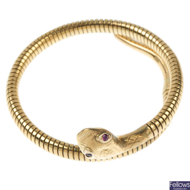 A mid 20th century 9ct gold ruby snake bangle.