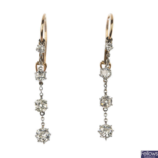 A pair of diamond four-stone ear pendants.