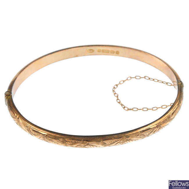 An Edwardian 9ct gold bangle and a paste signet ring.