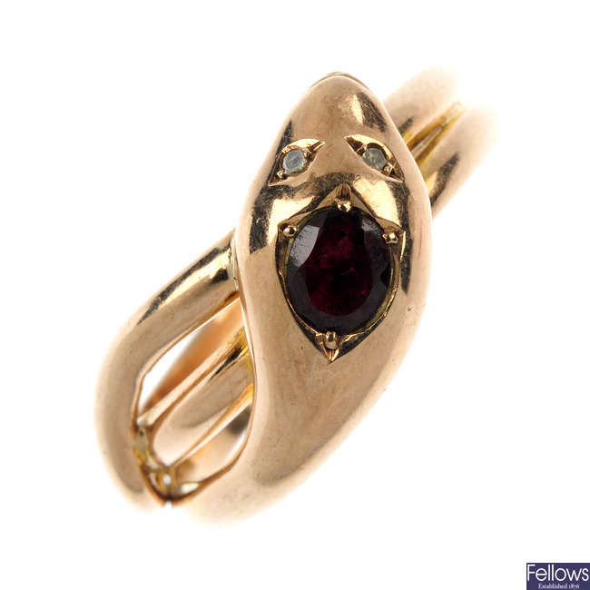 An early 20th century 9ct gold garnet and diamond snake ring. 
