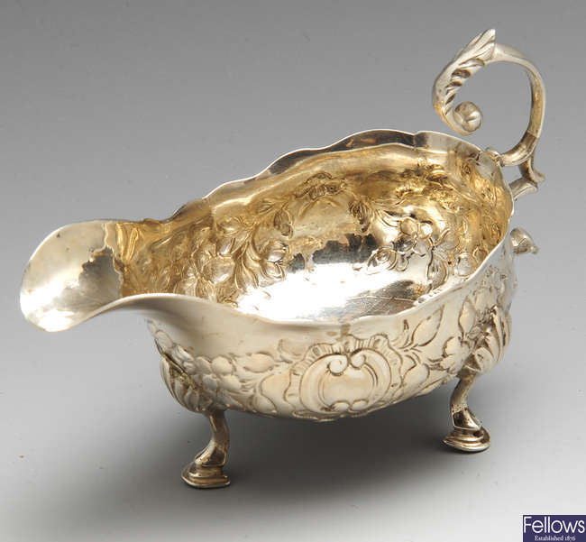 A George III silver sauce boat.