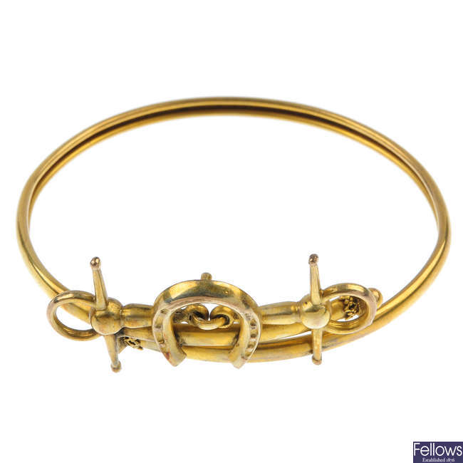 A late 19th century 9ct gold horseshoe bangle.