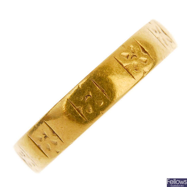 A 1960s 22ct gold floral engraved band ring. 