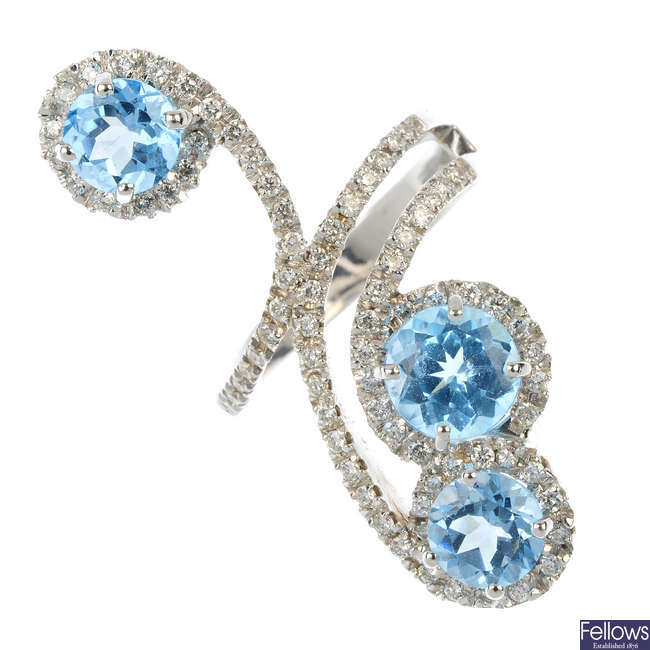 A diamond and topaz dress ring. 