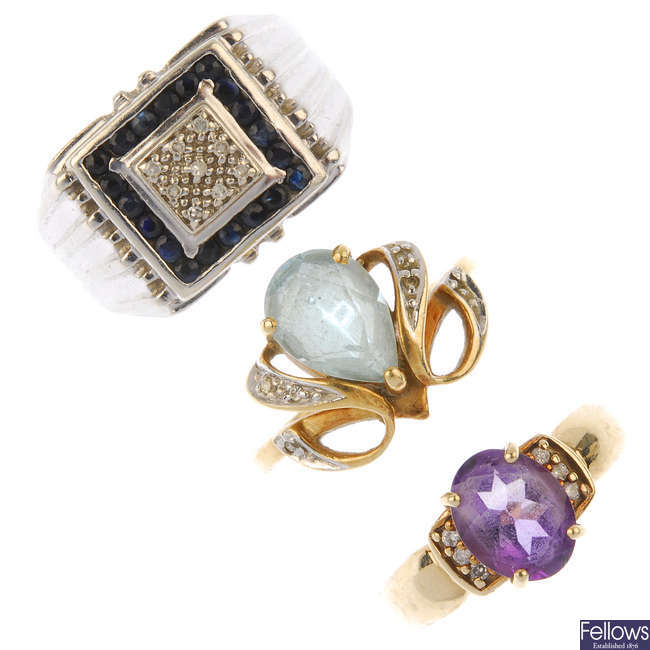 A selection of three gold gem-set rings. 
