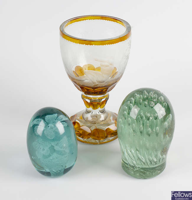 An etched glass goblet, plus two paperweights