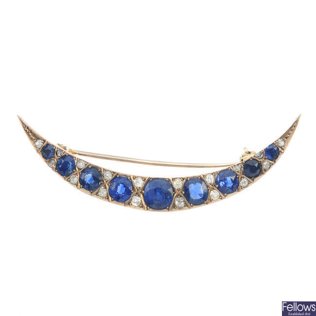 An early 20th century gold sapphire and diamond crescent brooch.