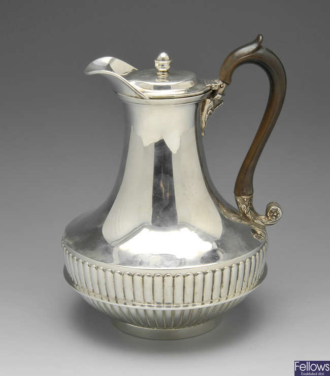 A George III silver hot water jug.