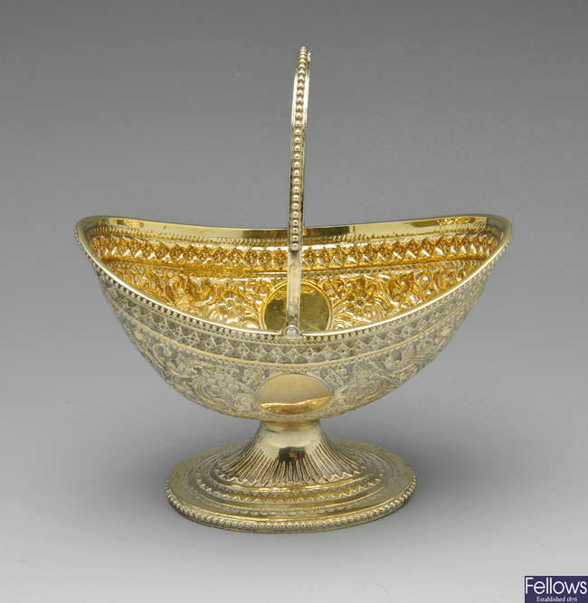 A Victorian silver-gilt sugar basket.