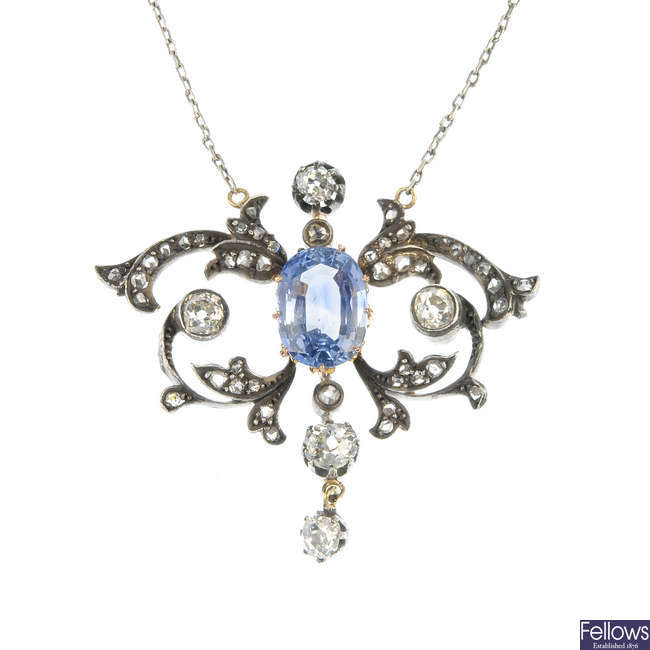 An early 20th century silver and 18ct gold sapphire and diamond pendant. 