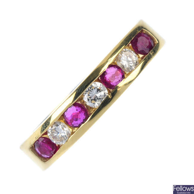 An 18ct gold ruby and diamond half eternity ring.